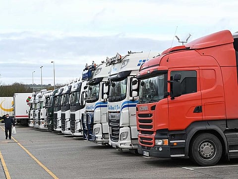 Freight lorries are parked at a truck stop off the M20 leading to Dover near Folkestone in Kent, south east England on December 22, 2020, after France closed its borders to accompanied freight arriving from the UK due to the rapid spread of a new coronavirus strain.