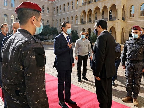 Lebanon's Prime Minister-designate Saad Hariri is greeted by Lebanon's caretaker Prime Minister Hassan Diab at the governemt palace in Beirut.