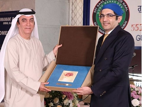 Dr Aman Puri hands over the book sent by Indian Prime Minister Narendra Modi to Dr Ahmed Al Banna in Dubai.
