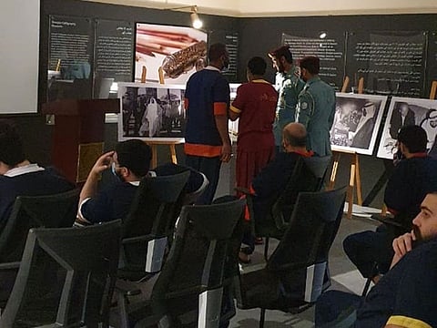Sharjah jail inmates at the exhibition of pictures on Sheikh Zayed's life.