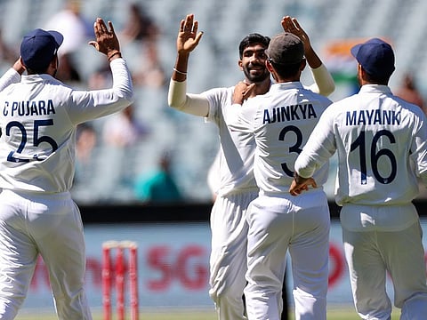 India's Jasprit Bumrah celebrates the wicket of Australia's Joe Burns
