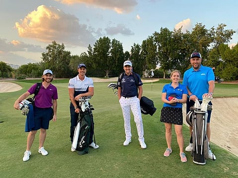 Dr Eleanor McCarthy with her husband Chris McCarthy (right - both in blue), with golf pros (from left) Tommy Fleetwood, Ryder Cup legend Ian Poulter and Lee Westwood.