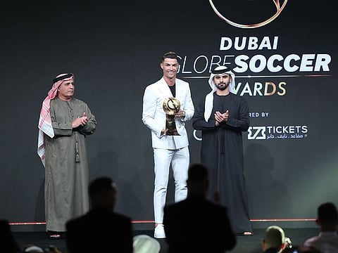 Shaikh Mansour Bin Mohammad Bin Rashid Al Maktou gives away the Best Male Player of the Year award to Cristiano Ronaldo, watched by Mattar Al Tayer, Deputy Chairman of the Dubai Sports Council, at the Golden Soccer Awards in Dubai.