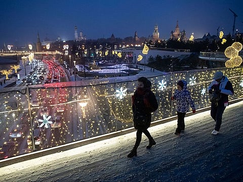 People walk on a bridge in Zaryadye Park with the Kremlin in the background, in Moscow. Oman citizens will be able to obtain an electronic visa to enter Russia from 2021.