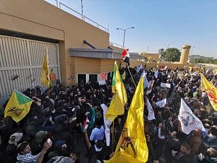 Protesters and militia fighters gather to condemn air strikes on bases belonging to Hashd al-Shaabi (paramilitary forces), outside the main gate of the U.S. Embassy in Baghdad, Iraq December 31, 2019.