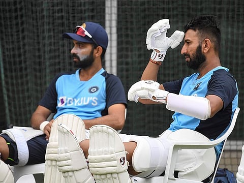 India's Cheteshwar Pujara (R) and Ajinkya Rahane (L) wait to bat during a training session at the MCG in Melbourne on January 2, 2021.