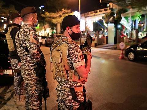 Lebanese security forces stand guard at a street full of restaurants where revelers celebrating the New Year Eve, in Beirut.