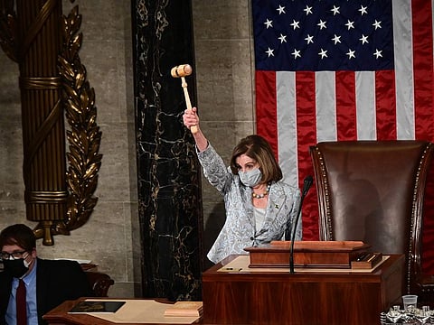 US Speaker of the House Nancy Pelosi wields the Speaker's gavel after being re-elected as Speaker as she prepares to swear in members of the 117th House of Representatives in Washington, DC on January 3, 2021.