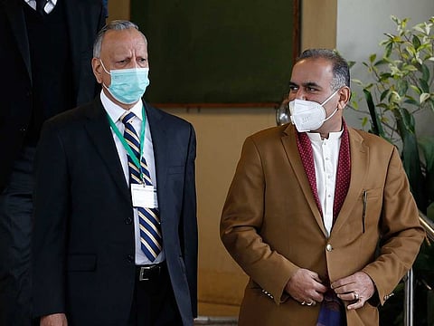 Ramesh Kumar, right, a lawmaker and a leader in the Hindu community and Shoaib Suddle, head of a Commission for Minorities Rights, leave the Supreme Court after a hearing in the case of a Hindu temple that was vandalised, in Islamabad, Pakistan, Tuesday, Jan. 5, 2021.