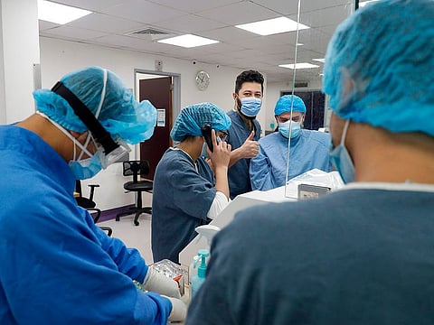 Healthcare workers gather the the nurses station in the intensive care unit of the Rafic Hariri University Hospital in the Lebanese capital Beirut, on January 5, 2021. - With 192,000 reported cases and almost 1,500 deaths, Lebanon is not among the world's worst hit countries, but its infrastructure is crumbling and a small surge in infections is enough to take its health sector to breaking point.