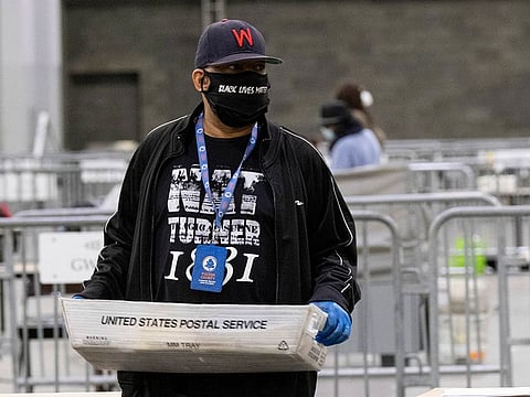 Fulton County Georgia elections workers process absentee ballots for the Senate runoff election in Atlanta on Tuesday, Jan. 5, 2021.