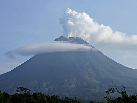Mount Merapi spews volcanic steam from its crater seen from Sleman, Yogyakarta, Indonesia, Thursday, Jan. 7, 2021. The 2,968-meter (9,737-foot) mountain spewed avalanches of hot clouds on Thursday morning amid its increasing volcanic activities.