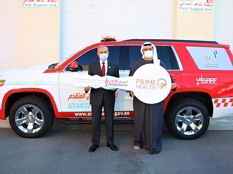 Dr Jamil Ahmed, Managing Director of Prime Health Care Group gifts the ambulance to Khalifa Hassan Abdul Karim Al Darrai, Executive Director of DCAS.