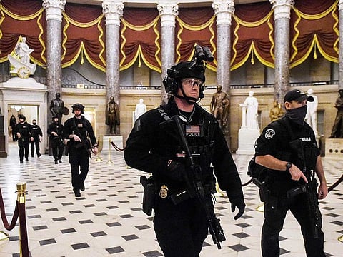 Members of the Swat team patrol and secure the Statuary Hall before US Vice-President makes his way into the House Chamber, at the US Capitol, on January 7, 2021 in Washington, DC.