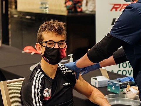 A member of the team gets a vaccine jab.