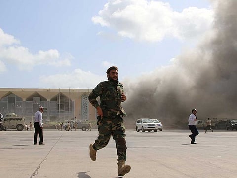 Security personnel and others react during an attack on Aden airport moments after a plane landed carrying a newly formed cabinet for government-held parts of Yemen, in Aden, Yemen December 30, 2020.