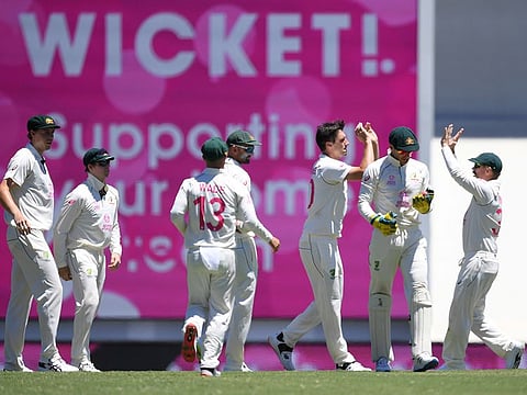 Australia players celebrate Pat Cummins' wicket of Cheteshwar Pujara of India during day three of the third test match between Australia and India at the SCG