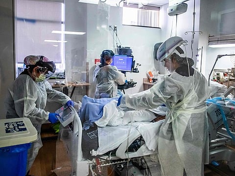 Nurses attend to a COVID-19 patient in the Intensive Care Unit (ICU) at Providence Cedars-Sinai Tarzana Medical Center in Tarzana, California.