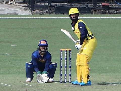 Dinesh Karthik, the Tamil Nadu skipper, gets ready to face a delivery as Jharkhand stumper Ishan Kishan watches on.