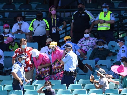 Police eject a group of spectators from their seats on Sunday a day after India's Mohammed Siraj complained to umpires of being racially abused during the Sydney Test on Saturday.