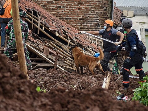 Rescuers search for survivors after two landslides killed at least 11 people, including a six-year-old boy, with scores more missing in Sumedang, West Java province on January 10, 2021.