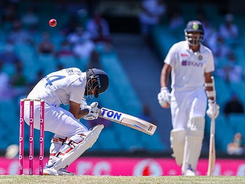 India's Hanuma Vihari avoids a bounder as non-striker Ravichandran Ashwin watches during the dramatic fifth day of the third Test match against Australia at the Sydney Cricket Ground. The match ended in a draw.