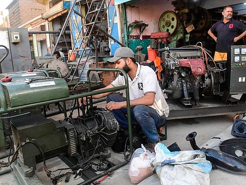 A technician repairs power generators of customers at his workshop a day after the country's power blackout in the Pakistan's port city of Karachi on January 11, 2021.