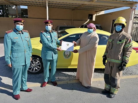Fujairah Civil Defence official hands over the citation to the family of Fatima Salem Al-Zeyoudi in recognition of her heroic attempt to save her family members during a fire at their house.