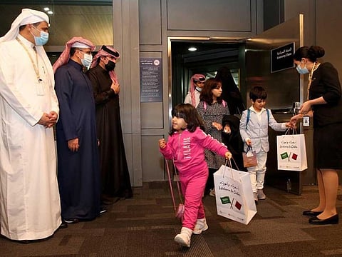 Passengers are welcomed upon arrival from Saudi Arabia in Doha.