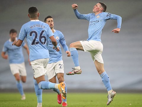 Phil Foden (R) celebrates his goal for Manchester City.