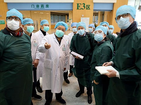 Experts from China and the World Health Organization (WHO) joint team wearing face masks visit Wuhan Tongji Hospital in Wuhan, the epicentre of the novel coronavirus outbreak, in Hubei province, China February 23, 2020.