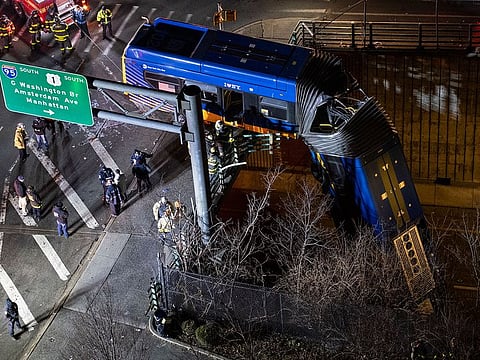 A bus in New York City which careened off a road in the Bronx neighborhood of New York is left dangling from an overpass Friday, Jan. 15, 2021, after a crash late Thursday that left the driver in serious condition, police said.
