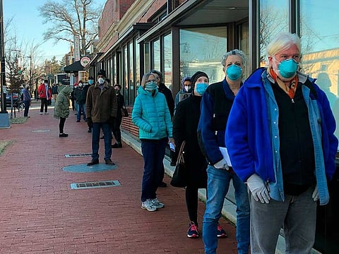 People 65 and older wait outside the Hattie Holmes Senior Wellness Centre in Washington, Jan. 12, 2021, to get a coronavirus vaccine.