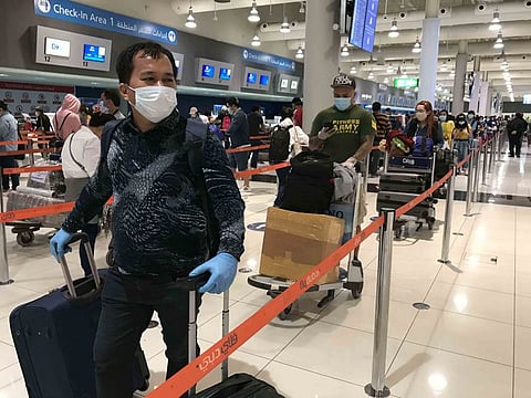 Expat Filipinos check in for their flights at Dubai International Airport.