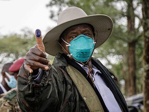 Ugandan President Yoweri Museveni shows his ink-marked thumb after casting his ballot at the Kaaroh high school polling station in Kiruhura, Uganda, on January 14 ,2021.