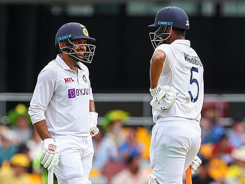 India's Shardul Thakur, left, and teammate Washington Sundar talk during play on day three of the fourth Test vs Australia at the Gabba, Brisbane, on January 17, 2021.