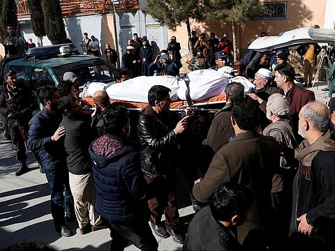 Relatives carry the body of one of the female judges shot dead by unknown gunmen in Kabul, on January 17, 2021.