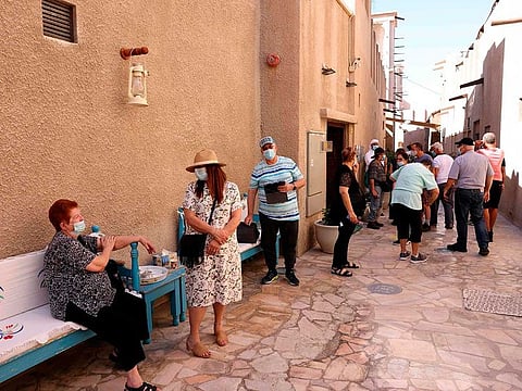 Mask-clad tourists visit the historic Al Fahidi neighbourhood of Dubai.