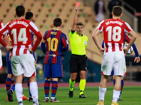 Barcelona's Lionel Messi is shown a red card by referee Jesus Gil Manzano.