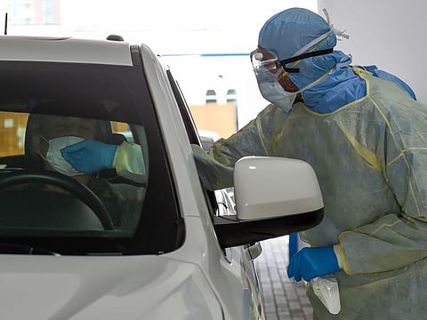 Paramedics collecting the swab samples at a coronavirus drive-through screening station by Dubai Health Authority at Al Nasr Club in Dubai Photo: Ahmed Ramzan/ Gulf News