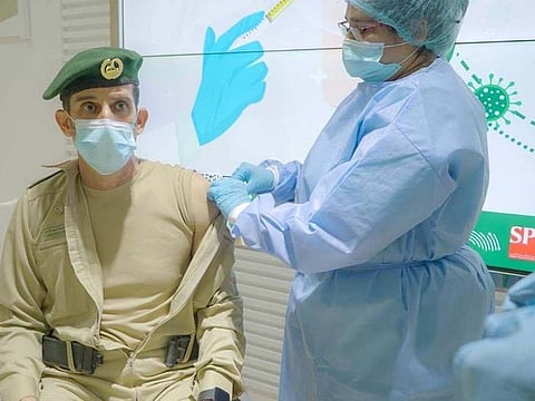 Lieutenant General Abdullah Khalifa Al Merri, Commander-in-Chief of Dubai Police, receives his first shot of the COVID-19 vaccine.