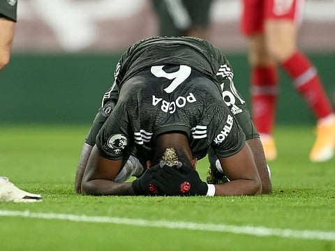 Paul Pogba looks defeated during goalless match against Liverpool at Anfield.