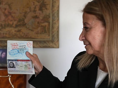 Dahouk Idriss shows a page on her passport during an interview with AFP at her house in the Syrian capital Damascus on January 16, 2021. - The Syrian mother says she cannot wait for US President-elect Biden to be inaugurated on January 20, so she can finally visit her son for the first time in four years. Biden has pledged that, on his first day of office, he would reverse a ban on travel to the United States from mostly-Muslim countries ordered by his predecessor Donald Trump.