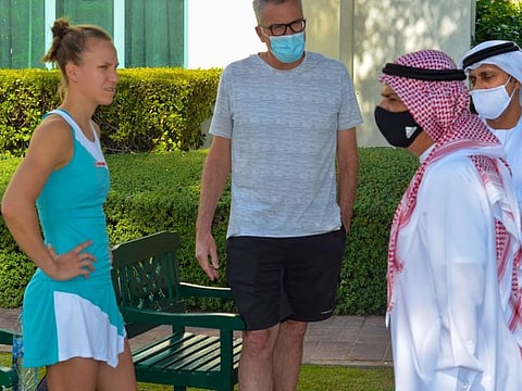 Abdul Ghafoor Behroozian, Chairman of the Fujairah Tennis and Country Club, speaks with a competitor at the Fujairah International Women Tournament