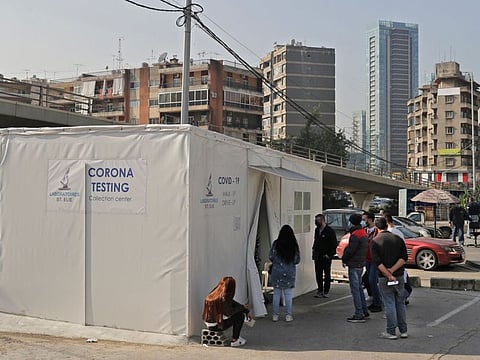 People line up to get tested for the coronavirus during a lockdown imposed by the authorities in a bid to slow the spread of the disease, in the town of Antelias, east of the Lebanese capital Beirut, on January 7, 2021.