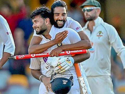 India's Shardul Thakur and Mohammad Siraj celebrate after defeating Australia by three wickets at the Gabba, Brisbane