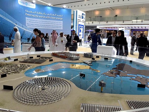 Visitors at the model of a solar project of Masdar at the Masdar pavilion at Abu Dhabi Sustainability Week during an earlier edition. The event is being held virtually for the first time this year.