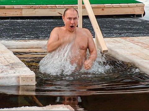 Vladimir Putin crosses himself while bathing in the icy water during a traditional Epiphany celebration outside Moscow.