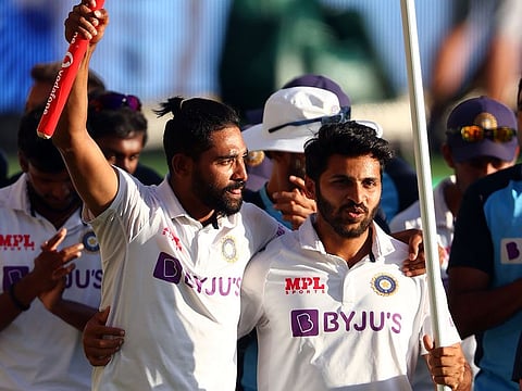 File photo: India's pacemen Mohammed Siraj (L) and Shardul Thakur celebrate the victory in the fourth Test against Australia at The Gabba in Brisbane.