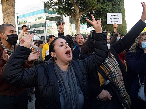 Tunisian protesters shout slogan during an anti-government demonstration on the Habib Bourguiba avenue in the capital Tunis, on January 20, 2021. - Young Tunisians clashed with security forces overnight and protest organisers called for anti-government rallies after five days of riots in disadvantaged neighbourhoods.